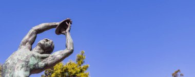 Athens, Greece - September 25, 2021: Bronze discobolus sculpture atlete in front of he Panathenaic Stadium or Kallimarmaro in Athens in Greece
