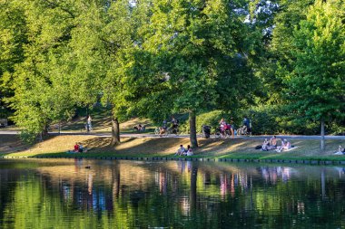 Groningen, The Netherlands - August 12, 2022: People relaxing in public park Noorderplantsoen in Groningen city The Netherlands at sunny evening in summer
