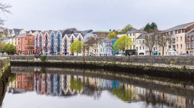 Cork, İrlanda - 16 Nisan 2023: İrlanda 'nın Munster bölgesindeki Lee nehri boyunca evleri olan Cork şehri manzarası