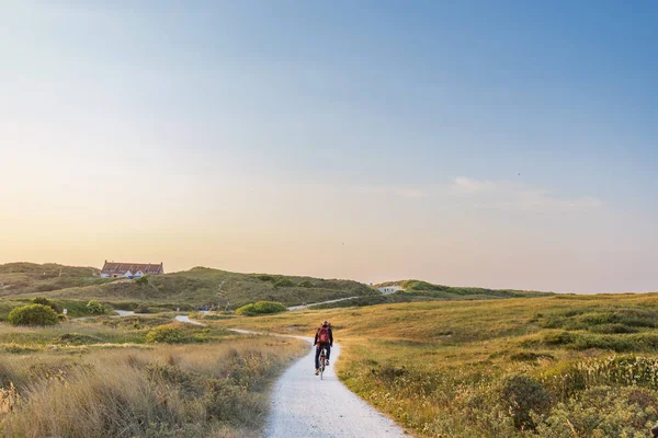 stock image Cyling during dusk to the beach of Formerum at Wadden island Terschelling Friesland province in The Netherlands