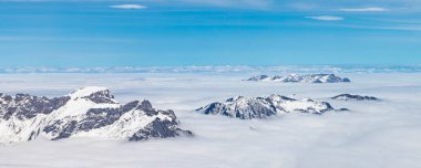 Engelberg İsviçre 'de Titlis Dağı' nın zirvesinden 3020 metre yükseklikteki bulutlar arasındaki tepeler görülüyor.