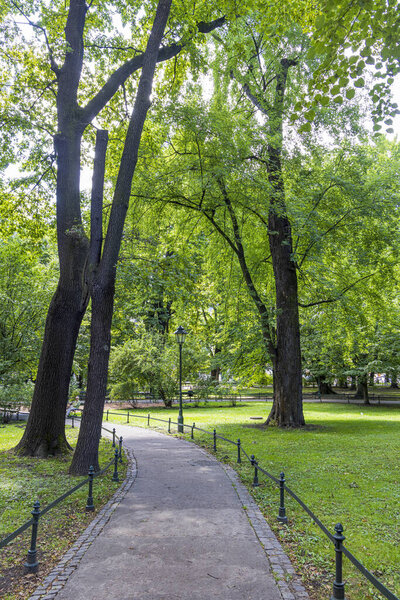 Walking along Planty park in Krakow in Poland. The park forms a popular scenic walkway around the old town