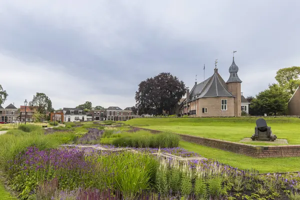 stock image Scenic view of beautiful park and garden with purple and blue flowers near the city hall and castle and canon of Coevorden in Drenthe The Netherlands