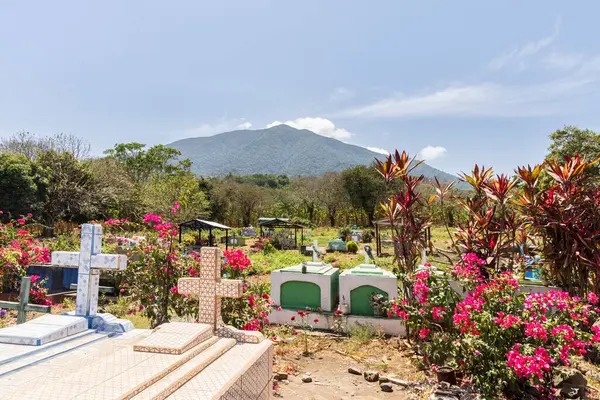 stock image Ometepe, Nicaragua - March 21, 2024 Colorful graveyard with volcano in background at Ometepe island in southwest Nicaragua Central America