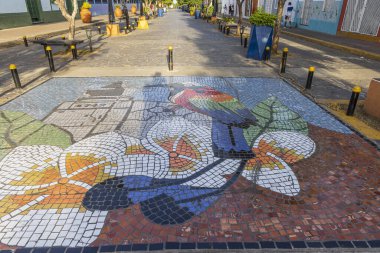 Granada, Nicaragua - March 20, 2024: Mosaic tile art of national bird turquoise-browed motmot guardabarranco in Callle la Calzada restaurants and bar street in Granada in Nicaragua Central America clipart