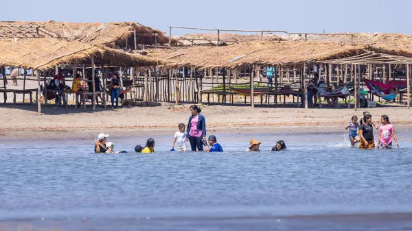 stock image Las Penitas, Nicaragua - March 17, 2024: Local family having fun at the coast of Las Penitas entrance to Juan Venado island nature reserve in Nicaragua Central America