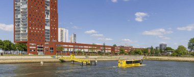 Rotterdam , The Netherlands - May 9, 2025: Panoramic view of tourist touring with Water bus along Katendrecht peninsula in port city Rotterdam in the Netherlands