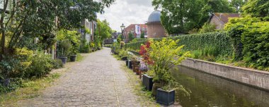 Leiden, The Netherlands - May 26, 2025: Panoramic view of urban greening with pots and plants in the streets of the student city Leiden in South-Holland The Netherland