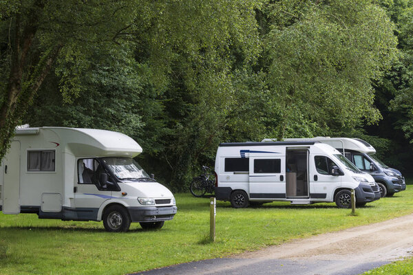 Row of camparevans along a dirt road at campground