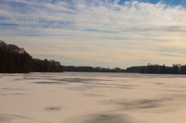 Trakai lake covered with ice in pleasant sunny cold winter day
