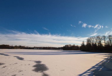 Trakai lake covered with ice in pleasant sunny cold winter day