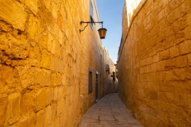 Mdina, Malta - 12 15 22: sandstone walls of narrow Mdina street.