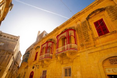 Mdina, Malta - 12 15 22: yellow sandstone facades and traditional maltese balconies.