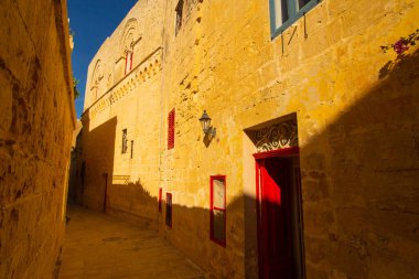 Mdina, Malta - 12 15 22: yellow sandstone facades of old buildings.