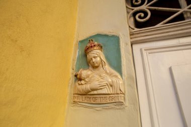 Traditional religious catholic bas-relief od Virgin Mary with baby Jesus near the building entrance in Mdina, Malta
