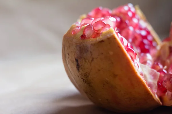close-up of a cut pomegranate with red grains - with empty space