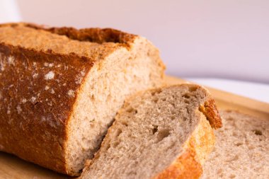 close-up photo of sliced bread with a longitudinal cut - on a white background