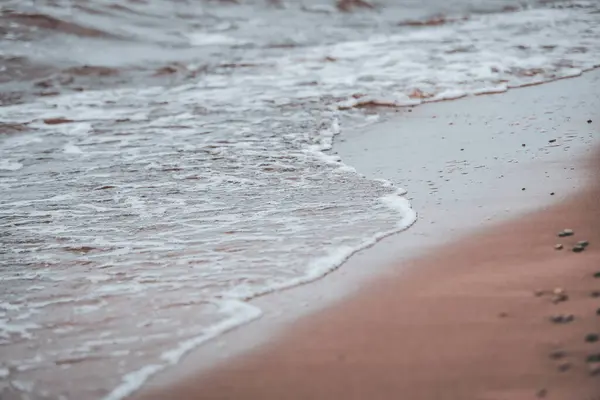 stock image Baltic sea shoreside view with sand and small waves. Photo taken on a cloudy, scandinavia style day. Photo taken in Latvia, Jurkalne.