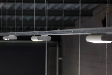 LED aydınlatma aletleri büyük kapalı bir arenada vidalanıyor. Fotoğraf buz hokeyi sahasında çekildi..