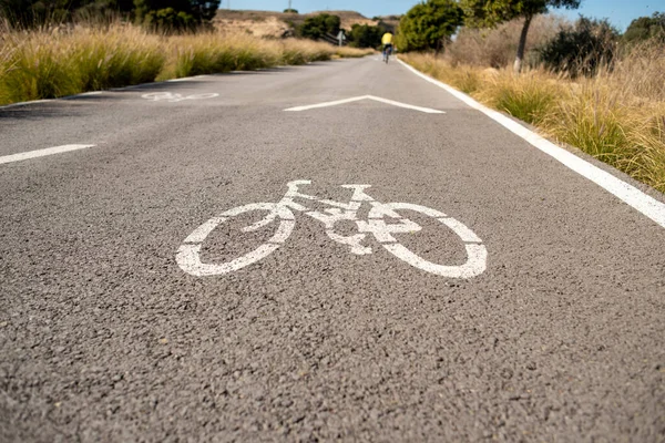 Continuous line on road. Cycle road. The journey continues. High quality photo Continuous line on road. Road in mountain. . High quality photo