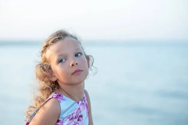 stock image The girl in the holiday dress against the sea. High quality photo