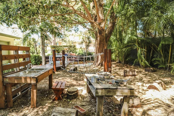 Mud kitchen in tropical preschool garden. Kindergarten yard in Australia.