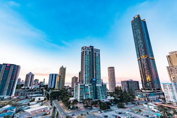 stock image Surfers Paradise QLD Australia - 9 July 2023: Highrise buildings, apartment blocks and upmarket hotels that form the Gold Coast city skyline with vibrant colored sky at sunset