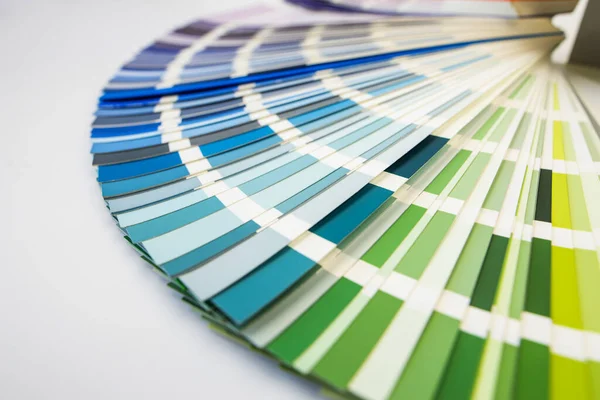 Stock image Color guide close up. Assortment of colors for design. Colors palette fan on white concrete wall background. Graphic designer chooses colors from the color palette guide. Coloured swatches catalogue