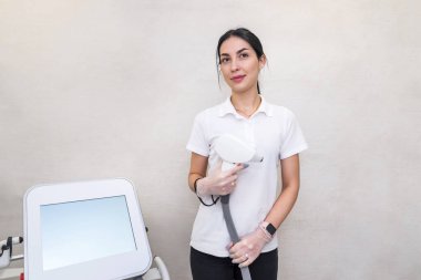 Portrait of a beautiful woman master of laser hair removal in a beauty salon