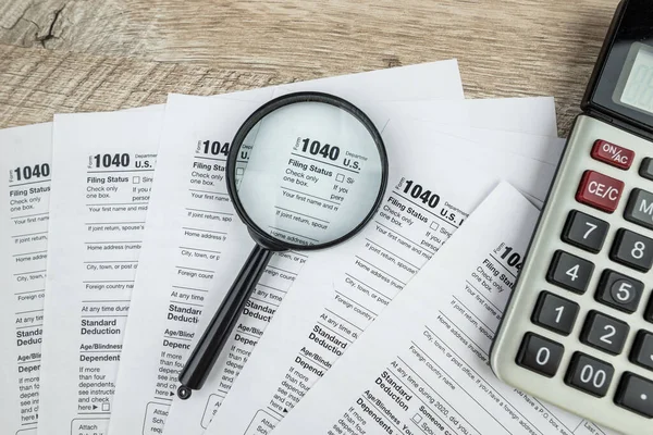 stock image blank of individual tax form with magnifying glasses, tax and income concept