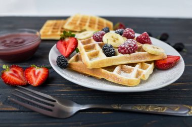 Kare Belçika waffleları ve ahşap bir arka plan. Lezzetli tatlı waffle.