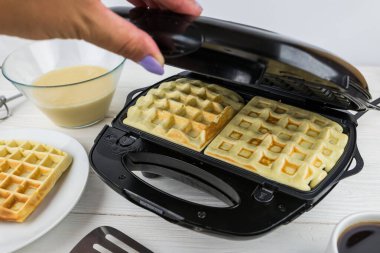 Evdeki waffle ızgarasında Belçika Waffle 'ı yapma sürecine yakın çekim. Waffle ızgarasında Belçika waffle 'ı.