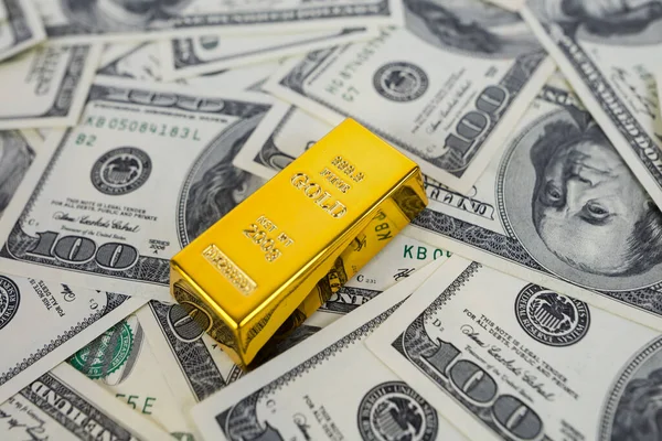one gold bar on dollars. Financial saving concept. gold and dollars.