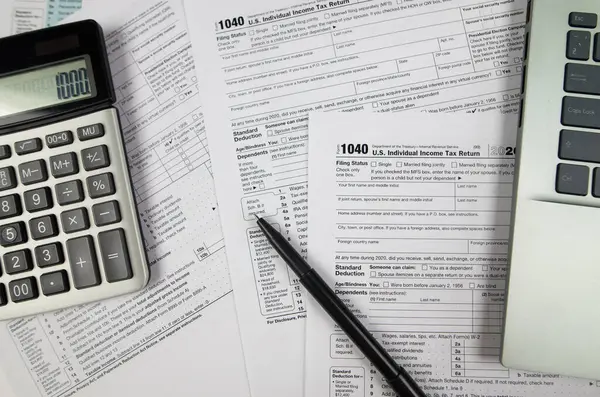 Tax time concept.Tax form with office supplies on white. financial document.Tax Form 1040. April Tax Time.