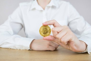 Bitcoin tutan kadının ofis masasında otururken çekilmiş fotoğrafı..