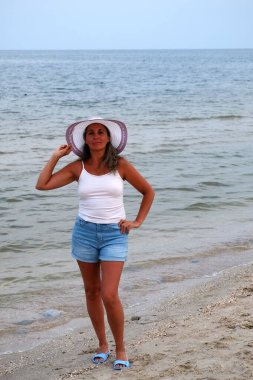 young woman in white shirt on the beach
