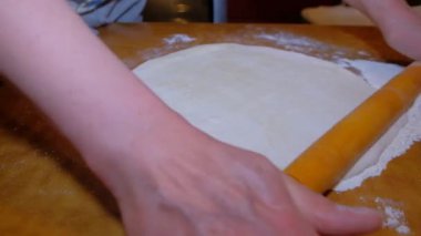 Evdeki kadın hamur yoğurarak pizzayı görünür hale getiriyor. İnsan eli ürünü görünür kılıyor. Masanın üzerindeki tüm eylemler.