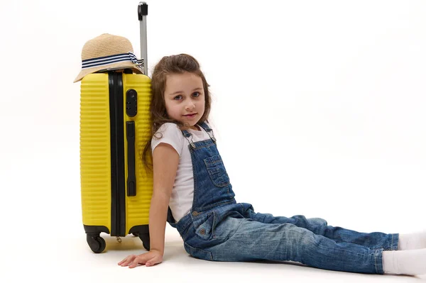 Happy Little Traveler Girl Denim Overalls Sitting Leaning Her Yellow — Stock Photo, Image
