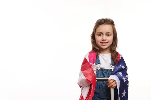American citizen, little girl with US flag and suitcase, isolated over white background with ad space for your promotional text. English language courses. Study in America. Winning green card lottery