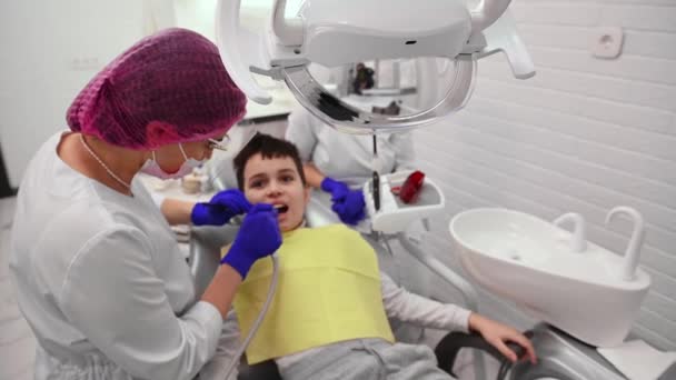 Dentist Hygienist Examining Child Teeth Gums Treating Curing Caries Modern — Video