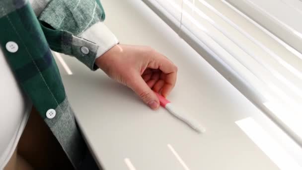 Close Hand Woman Putting Pregnancy Test Kit Windowsill Awaiting Result — Video Stock