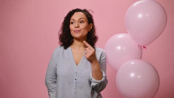 Attractive Hispanic Woman Shows Silence Sign Winks Camera Points Index — Stok video