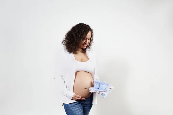 Smiling Curly Haired Young Charming Pregnant Woman Admiring Clothes Her — стоковое фото