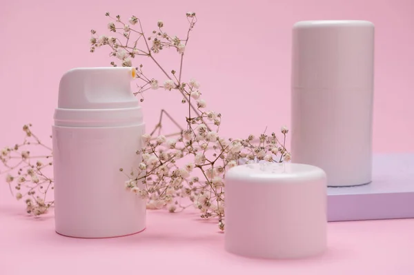 stock image Herbal cosmetics and beauty products in white bottles on a pink background. Mockup packaging, branding and design with copy space for your advertising and promotional text. Skin and body care concept