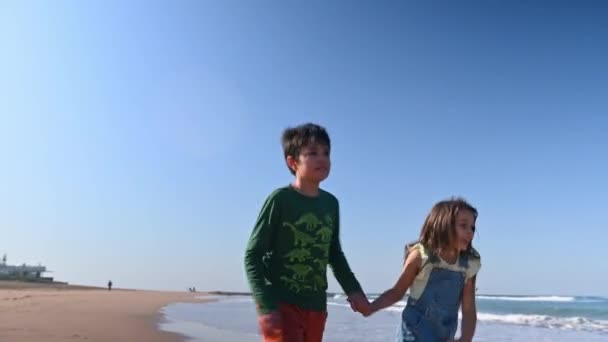Two Children Boy Girl Holding Hands Walking Barefoot Sandy Beach — Stock Video