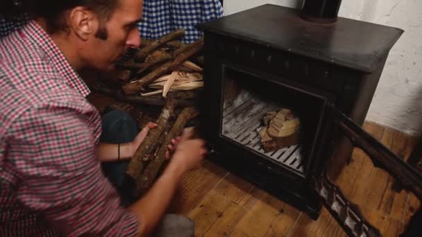 Close Handsome Man Putting Dry Firewood Logs Wood Burning Stove — Stock Video