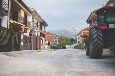 Luxury cottages and villas in the city of Quesada of the region of Jaen in Spain. A partial view of tractor parked on the road. The province of Jaen. Olive paradise. Countryside and rural lifestyle clipart