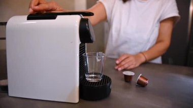 Kadın güne kahve makinesiyle espresso yaparak başlıyor.