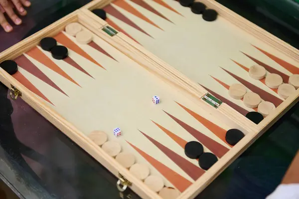 stock image Wooden backgammon board setup featuring dice and checkers, ready for strategic gameplay. Ideal for family fun, competitive gaming, and social gatherings. Captures essence of traditional board games.