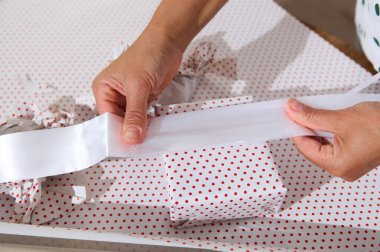 Beyaz kurdele ve puantiyeli kâğıt ile hediye paketleri, hediye hazırlıklarını ve şenlikli etkinlikleri gösteren yakın çekim..